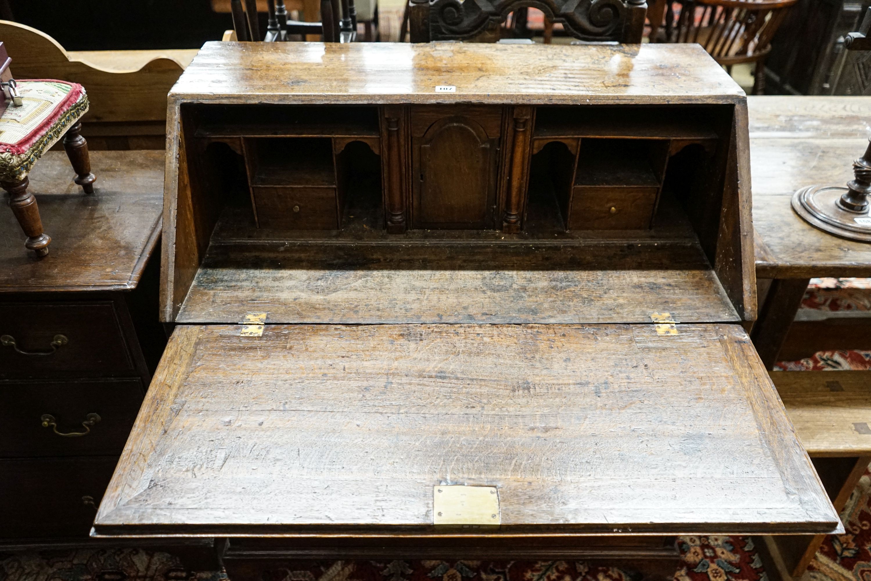 A George III oak bureau, with fitted interior, two short and three long drawers, width 92cm, depth 50cm, height 100cm